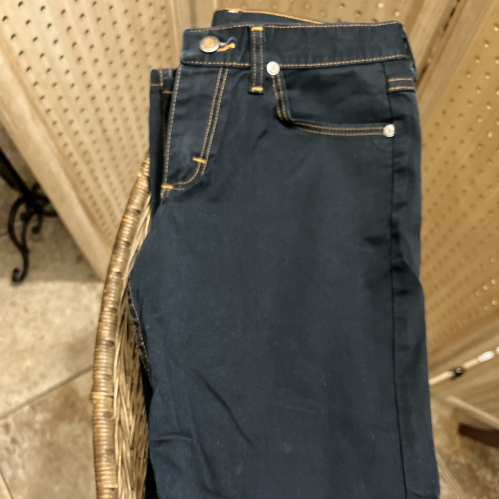 Women’s denim size 3, medium. Darker wash with orange threading throughout.